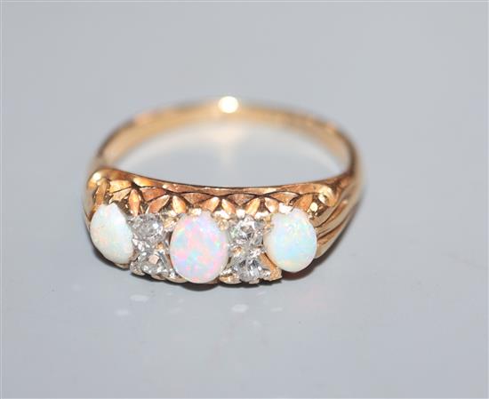 An 18ct and plat, white opal and diamond set half hoop ring, size K.